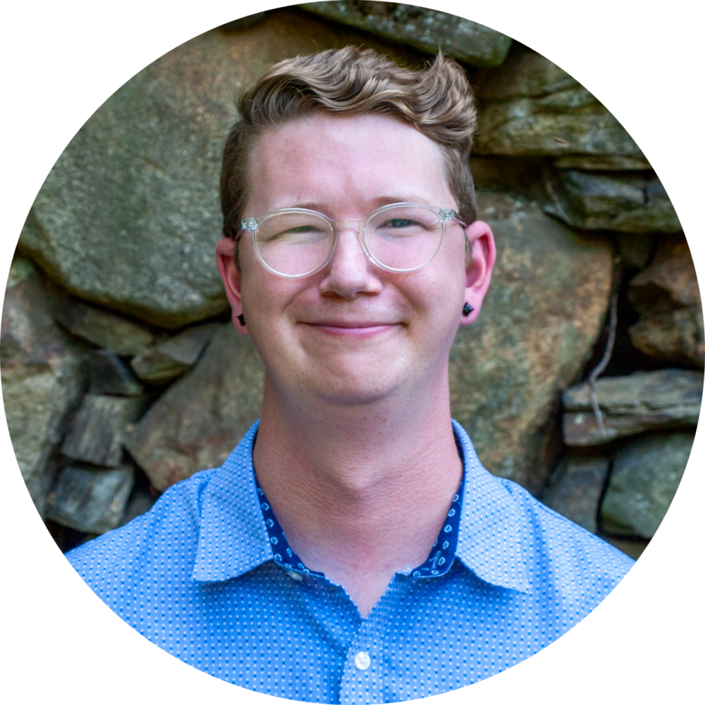 Peter Blair, State Policy Director wearing blue shirt and smiling.