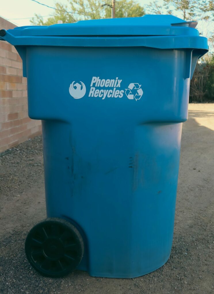 Blue recycling bin on curb
