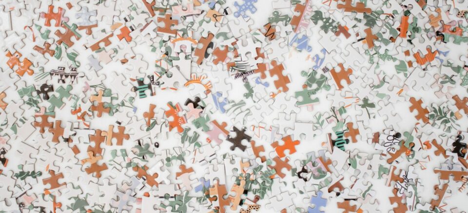 White, orange, light blue, sage green, pink, and tan puzzle pieces