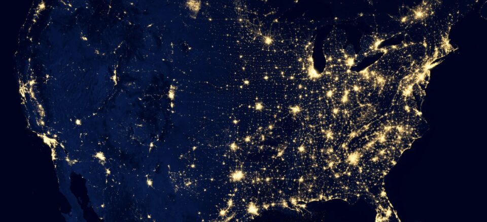 United States seen from orbit with populated areas lit up.