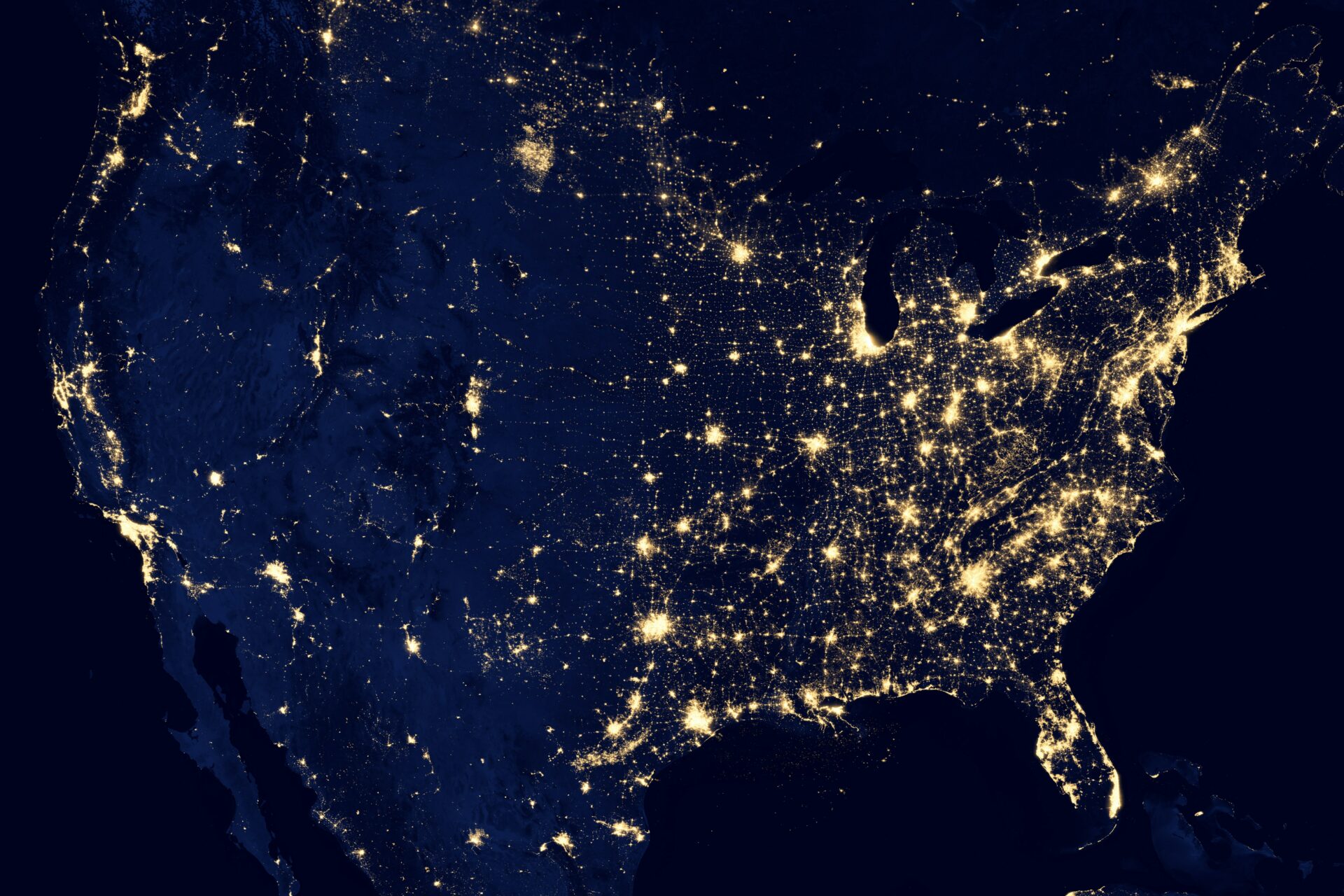 United States seen from orbit with populated areas lit up.