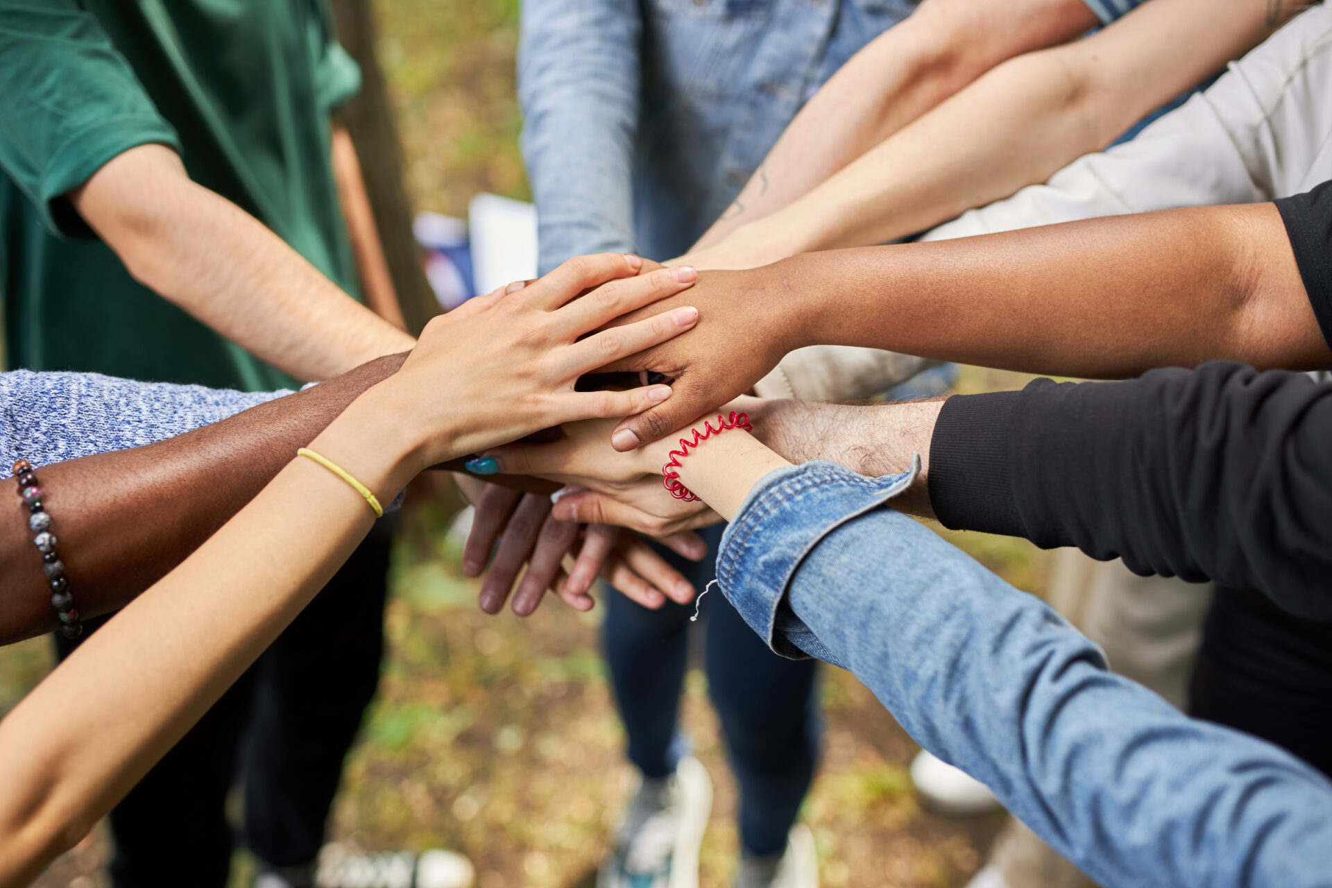 Close-up photo of diverse people's hands gathered together
