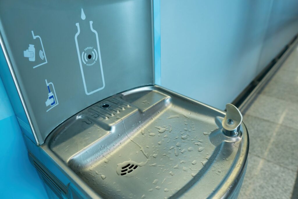 Close-up of a drinking fountain and water bottle filling station