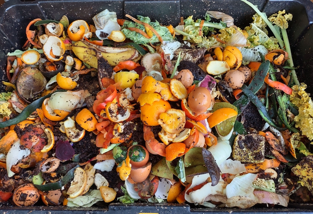 Compost bin with layers of organic matter and soil.