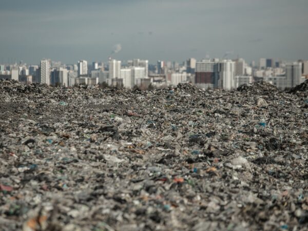landfill in focus with city line out of focus in the back highlights environmental injustice