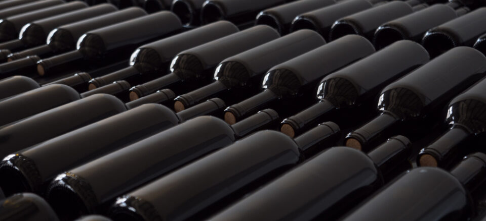 Rows of clean wine bottles without labels