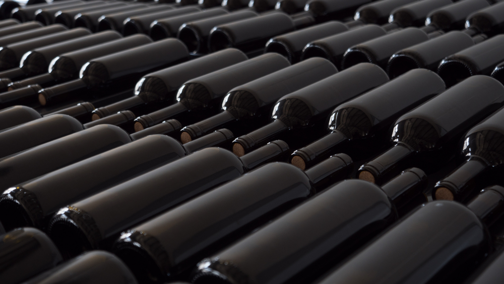 Rows of clean wine bottles without labels