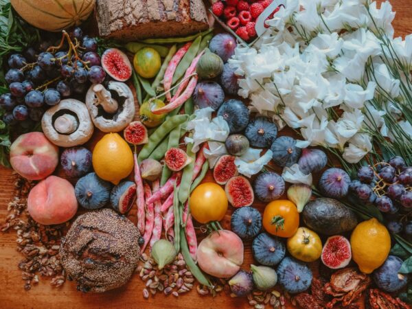 A top view of a wooden table with colorful food on top of it.