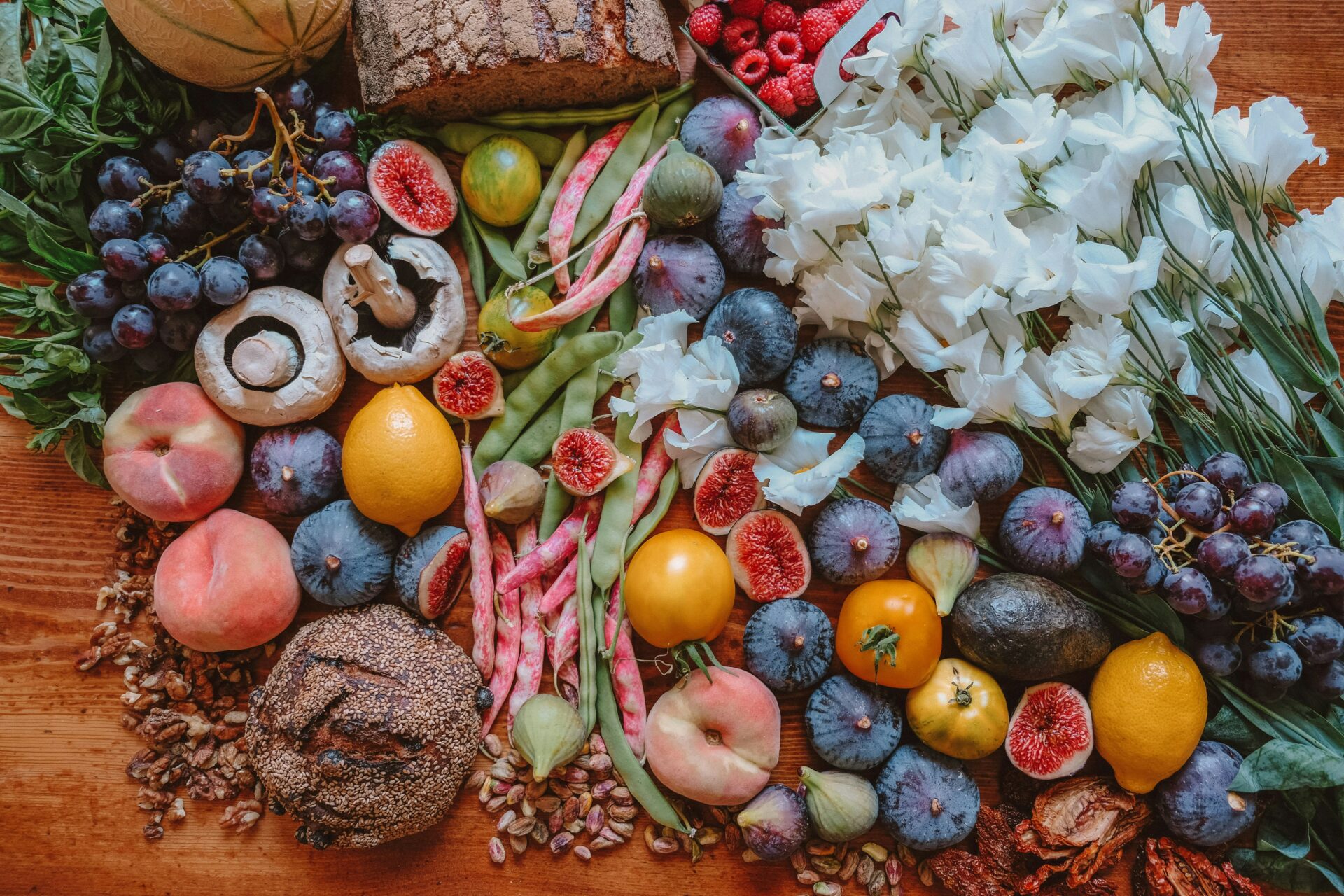 A top view of a wooden table with colorful food on top of it.