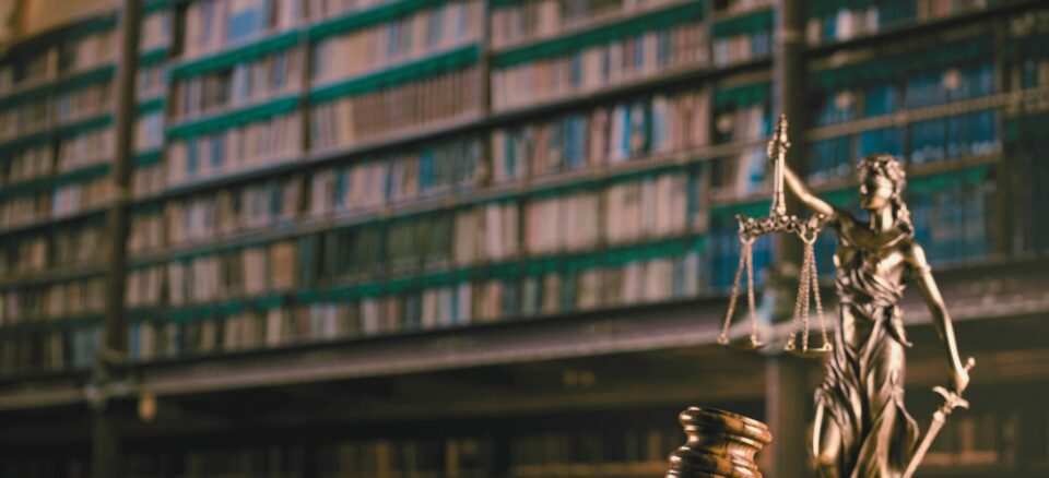 gavel and justice statue with library backdrop