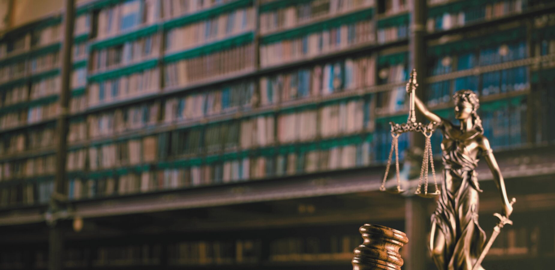 gavel and justice statue with library backdrop