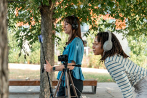 Two Just Zero staff members filming outside