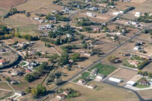 Aerial view of homes with brown grass