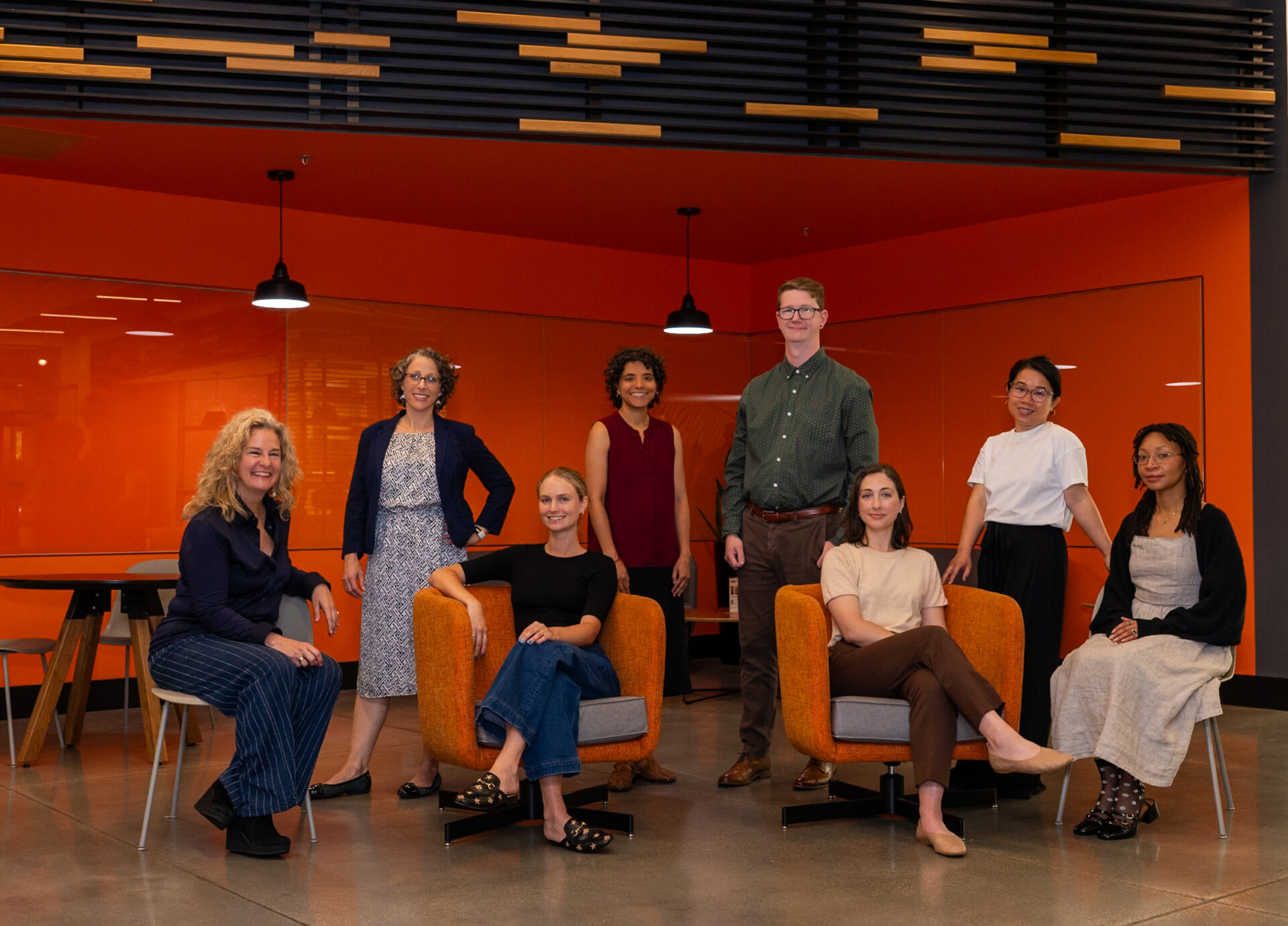 Just Zero team in front of orange room