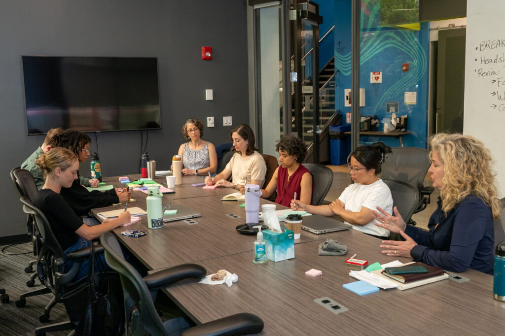 Just Zero staff sitting around conference room table